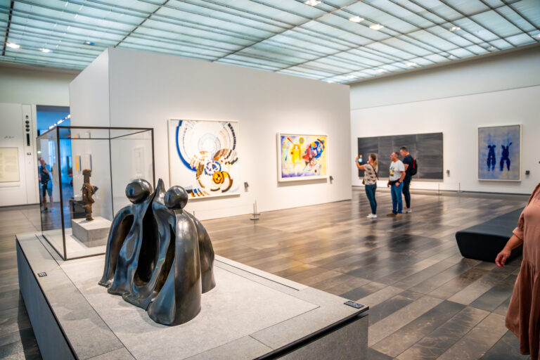 Abu Dhabi, UAE - December 6, 2023: Interior of Louvre and Visitors looking at exhibits, museum in Abu Dhabi, UAE